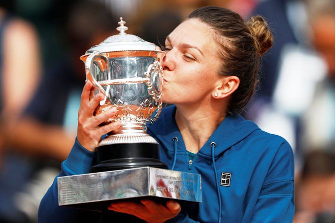 Romania's Simona Halep kisses the trophy after beating USA's Sloane Stephens to win the 2018 French Open final at Roland Garros in Paris on Saturday