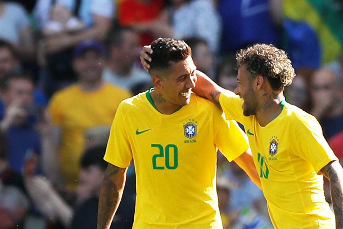 Brazil's Roberto Firmino and Neymar celebrate a goal. Brazil begin their campaign against Switzerland on Sunday