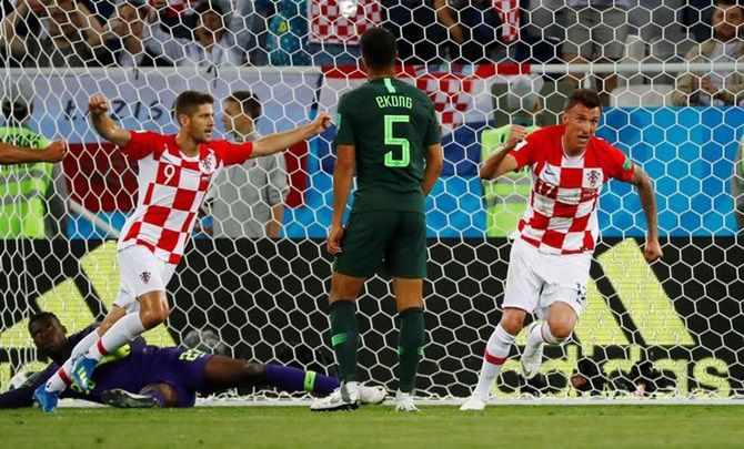 Croatia's Mario Mandzukic and Andrej Kramaric celebrate after Nigeria's Oghenekaro Etebo scores an own goal