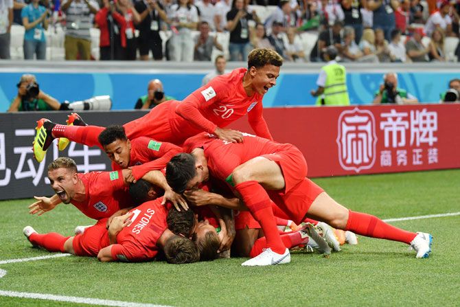 England captain Harry Kane celebrates with teammates after scoring the first goal against Tunisia 