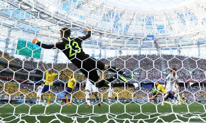 South Korea's Cho Hyun-woo dives to make a save to deny Sweden