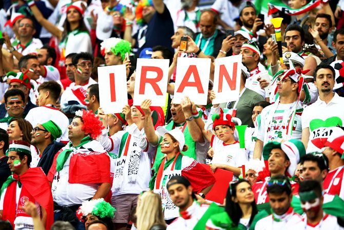 Iranian fans show their support during the match against Spain