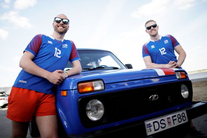 Kristbjorn Hilmir Kjartansson (right) and Gretar Jonsson, Iceland's supporters, pose for a picture with their Lada after a journey from home to Russia to watch their team at the FIFA World Cup on Wednesday