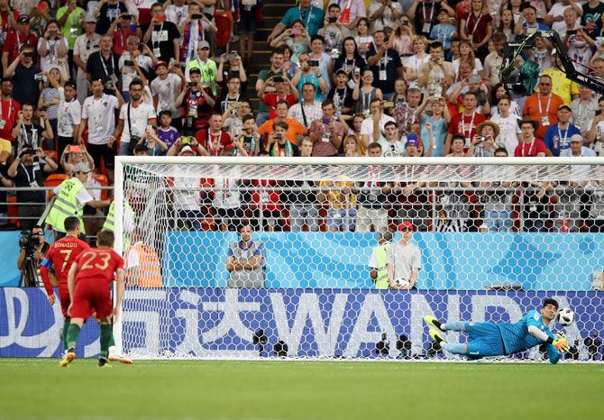 Iran's keeper Ali Beiranvand saves a penalty from Cristiano Ronaldo