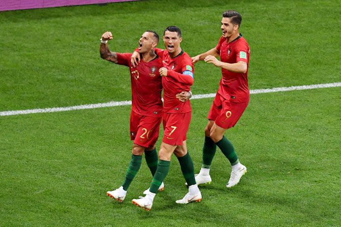 Portugal's Ricardo Quaresma celebrates with teammates Cristiano Ronaldo and Andre Silva after scoring his team's first goal against Iran