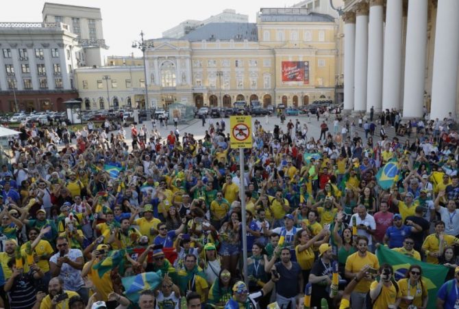 Brazil soccer team fans sing and dance near the Bolshoi Theatre in central Moscow on Tuesday