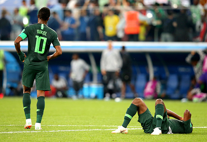 Nigeria's Odion Ighalo lies on the floor dejected as John Obi Mikel walks off during the 2018 FIFA World Cup Russia Group D match against Argentina at Saint Petersburg Stadium in Saint Petersburg, Russia, on Tuesday