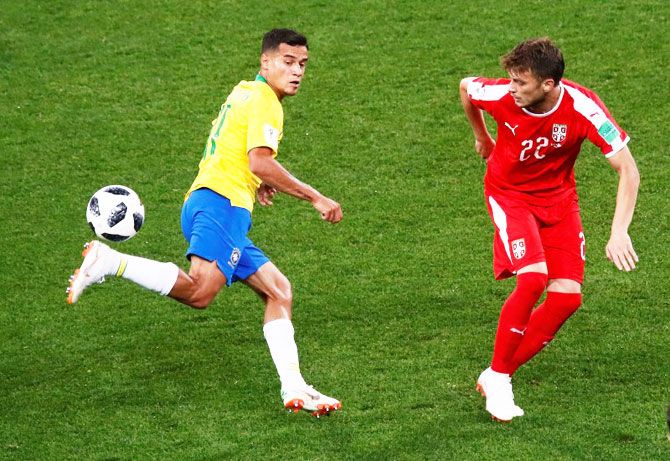 Brazil's Philippe Coutinho wins the ball in a challenge against Serbia's Adem Ljajic