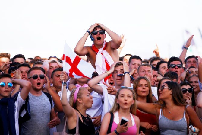 England fans react as they watch the match between England and Belgium in Brighton on Thursday