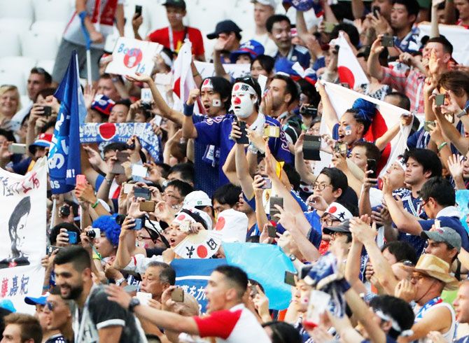 Japan fans celebrate after the match against Poland on Thursday