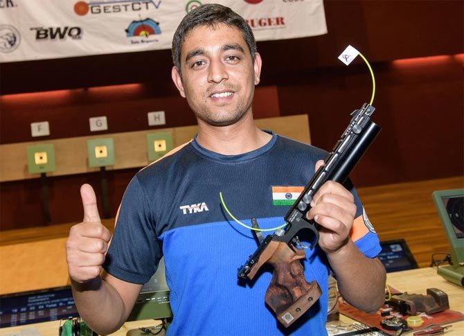 Shahzar Rizvi celebrates after winning the gold medal in the 10m air pistol event