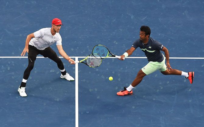 Jamie Cerretani and Leander Paes in action against Jean-Julien Rojer and Horia Tecau during the ATP Dubai Duty Free Tennis Championships men's doubles final at the Dubai Duty Free Stadium in Dubai, United Arab Emirates, on Saturday