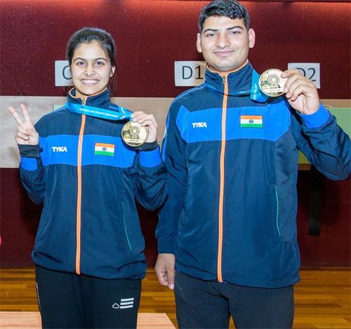 India's Manu Bhaker and Om Prakash Mitharval show off their medals after claiming the 10m air pistol mixed team title