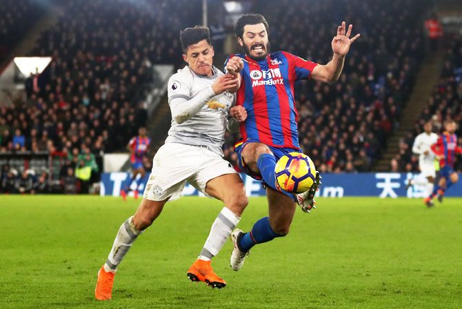 Manchester United's Alexis Sanchez and Crystal Palace's James Tomkins vie for possession