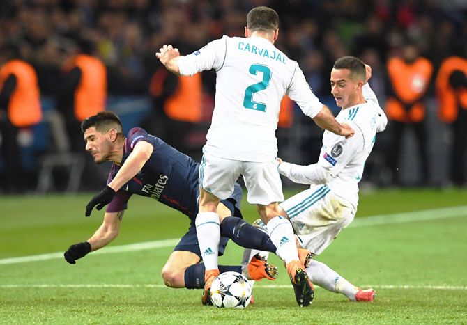 PSG's Yuri Berchiche is challenged by Real Madrid's Daniel Carvajal and Lucas Vazquez