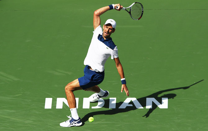 Serbia's Novak Djokovic plays a shot during his match against Japan's Taro Daniel at the BNP Paribas Open at the Indian Wells Tennis Garden