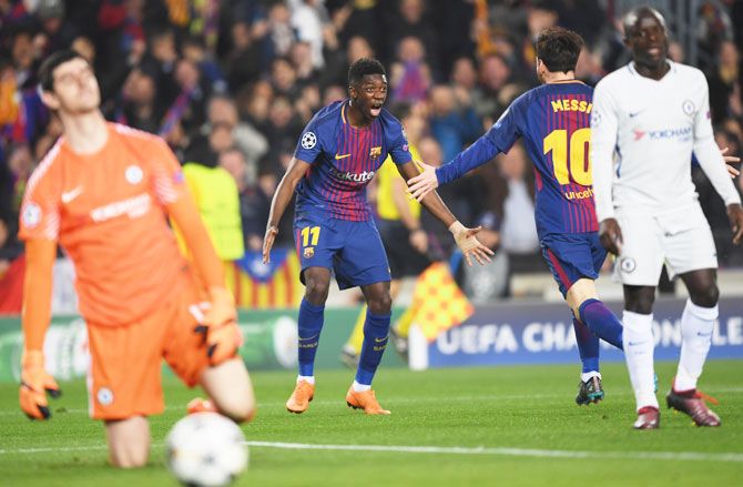 Barcelona's Ousmane Dembele celebrates with teammate Lionel Messi as he scores their second goal as Thibaut Courtois and N'Golo Kante of Chelsea look dejected