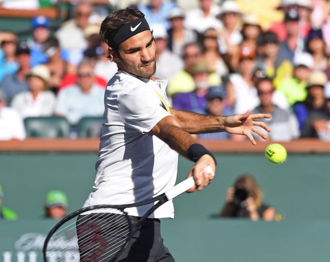 Switzerland's Roger Federer plays a return during his fourth round match against France's Jeremy Chardy