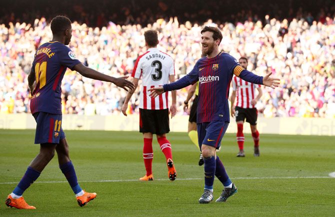 Barcelona’s Lionel Messi celebrates with Ousmane Dembele after scoring their second goal against Athletic Bilbao at Camp Nou on Sunday