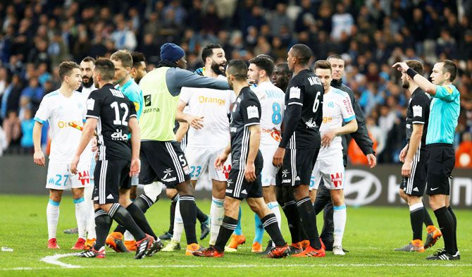 Marseille's Adil Rami and players clash after their match