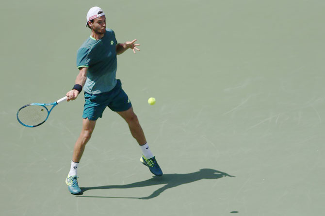 Joao Sousa of Portugal hits a forehand against Ryan Harrison of the United States (not pictured) of on day two of the Miami Open at Tennis Center at Crandon Park on Wednesday