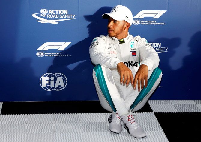 Mercedes' Lewis Hamilton relaxes in the paddock after qualifying on Saturday