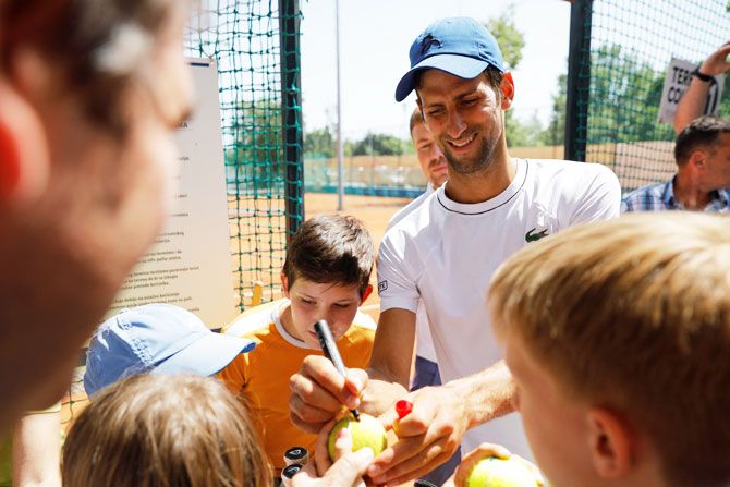 Novak Djokovic of Serbia signs autographs after a training session in Belgrade, Serbia, on Wednesday