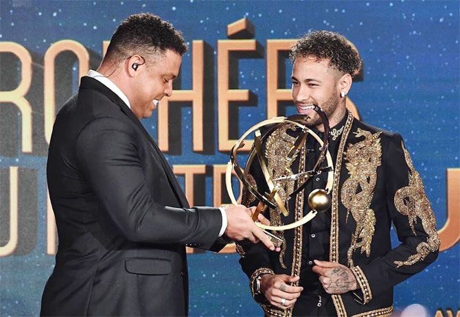PSG's Neymar receives the France player of the year award from compatriot and former Brazil great Ronaldo (left)