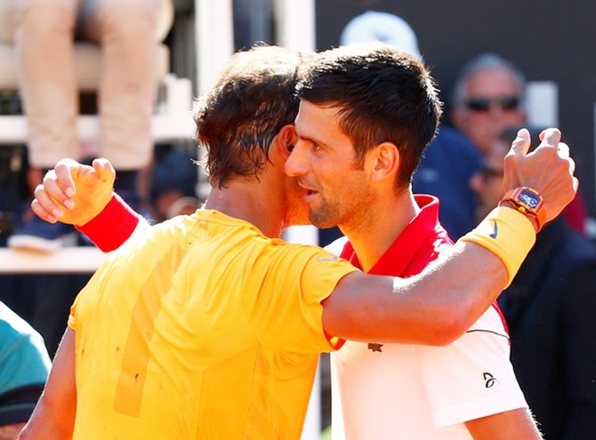  Rafael Nadal hugs Serbia's Novak Djokovic after winning their semi-final. 