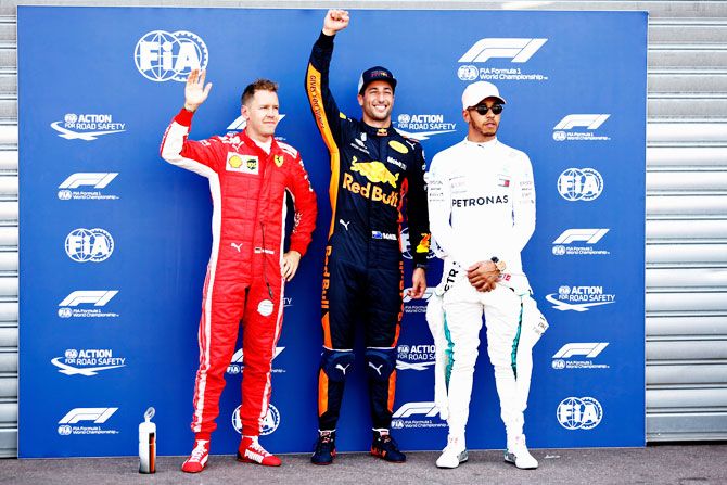 Top three qualifiers Daniel Ricciardo of Australia and Red Bull Racing, Sebastian Vettel of Germany and Ferrari and Lewis Hamilton of Great Britain and Mercedes GP pose for a photo in parc ferme during qualifying for the Monaco Formula One Grand Prix at Circuit de Monaco in Monte-Carlo, Monaco, on Saturday