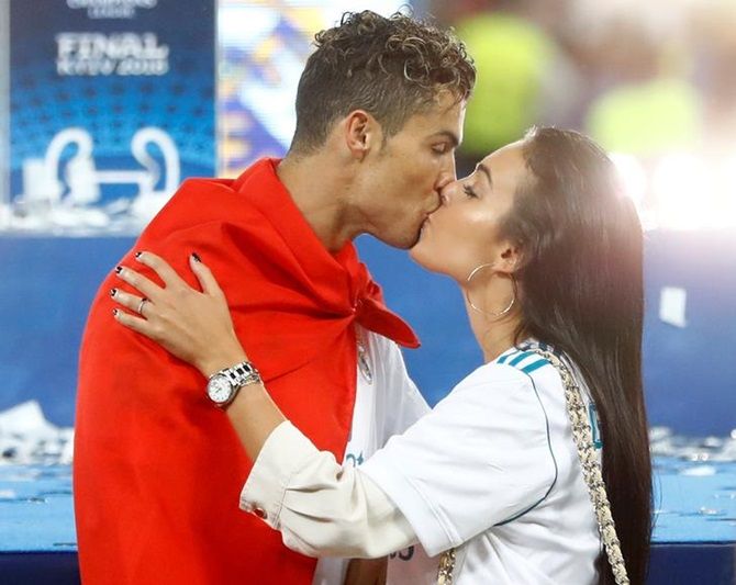 Cristiano Ronaldo kisses his girlfriend Georgina Rodriguez as he celebrates winning the Champions League.