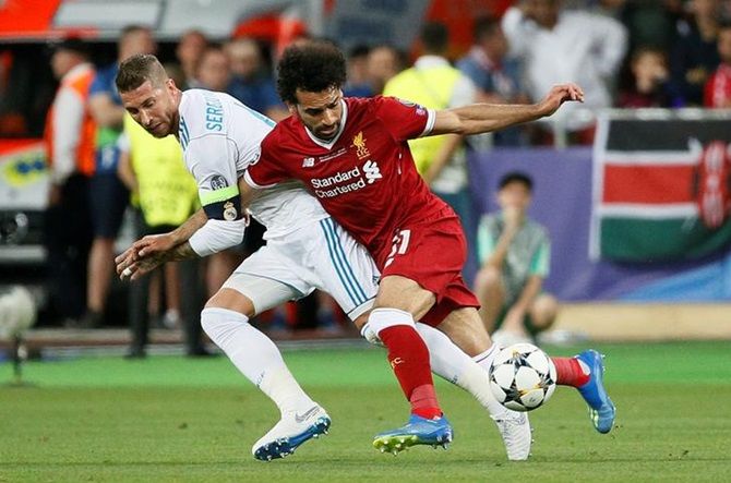 Liverpool’s Mohammad Salah, right, and Real Madrid’s Sergio Ramos battle for possession. Salah injured his shoulder following the tackle from Ramos