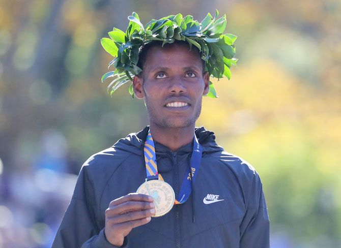 Ethiopia's Lelisa Desisa poses with his first place medal at the finish line after winning the 2018 TCS New York City Marathon in Central Park in New York City on Sunday