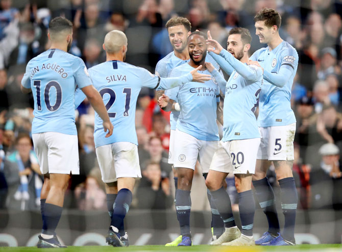 Manchester City's Raheem Sterling celebrates with teammates after scoring his team's fifth goal against Southampton FC at Etihad Stadium in Manchester