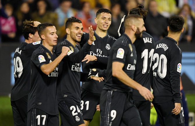 Real Madrid's Dani Ceballos celebrates scoring their fourth goal with teammates during their match against Celta Vigo on Sunday