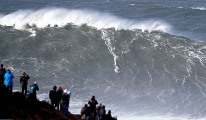 Big-wave surfer Sebastian Steudtner of Germany drops in a large wave at Praia do Norte in Nazare, Portugal on Friday, November 9
