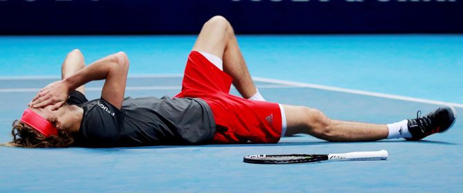 Alexander Zverev falls to the ground after winning match point