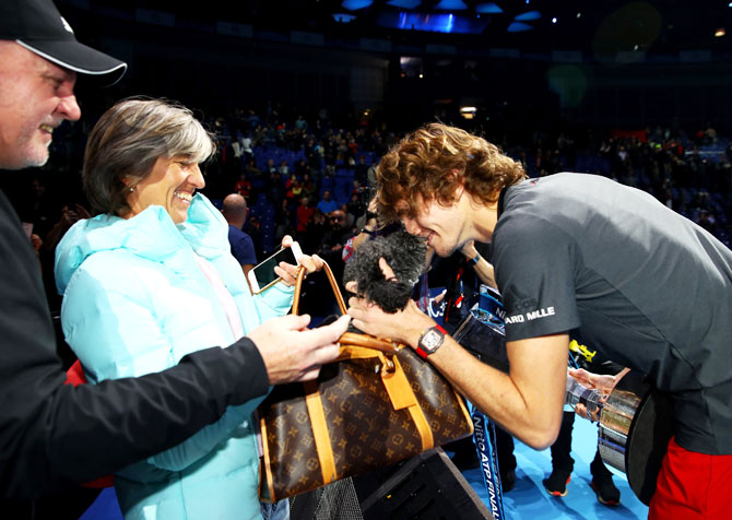 Alexander Zverev celebrates with his mum, Irina Zvereva and the family dog following his victory on Sunday