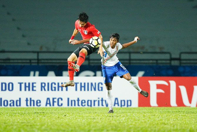 Players of the Indian and Korean team vie for possession in an aerial challenge