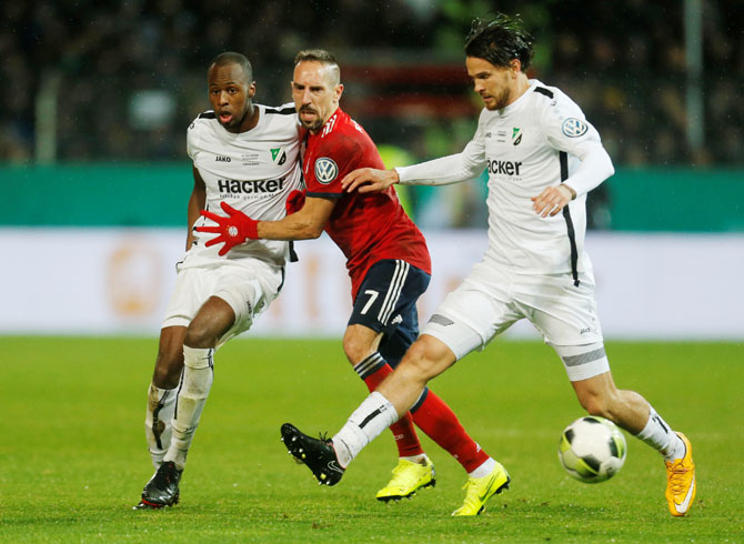 SV Roedinghausen's Kelvin Lunga and Azur Velagic vie with Bayern Munich's Franck Ribery during their DFB Cup second round match at Stadion an der Bremer Brucke, in Osnabruck, Germany, on Tuesday