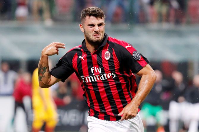 AC Milan's Patrick Cutrone celebrates scoring their second goal against AS Roma during their Serie A match at the San Siro in Italy on Friday