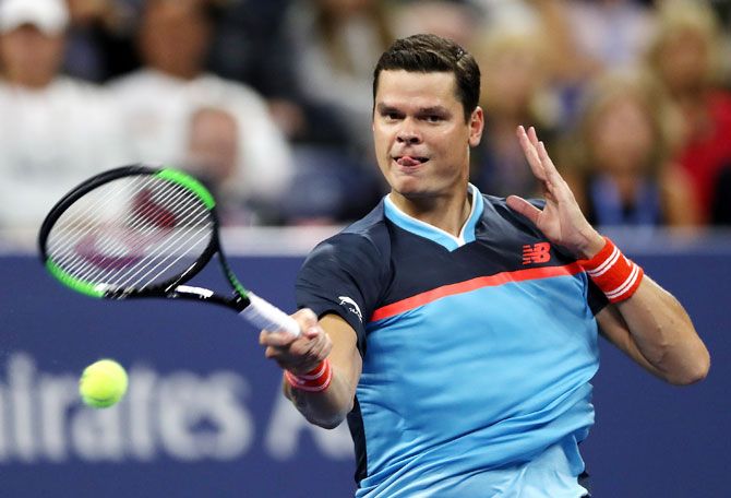 Canada's Milos Raonic returns the ball during the men's singles second round match against Stan Wawrinka at the USTA Billie Jean King National Tennis Center on Friday