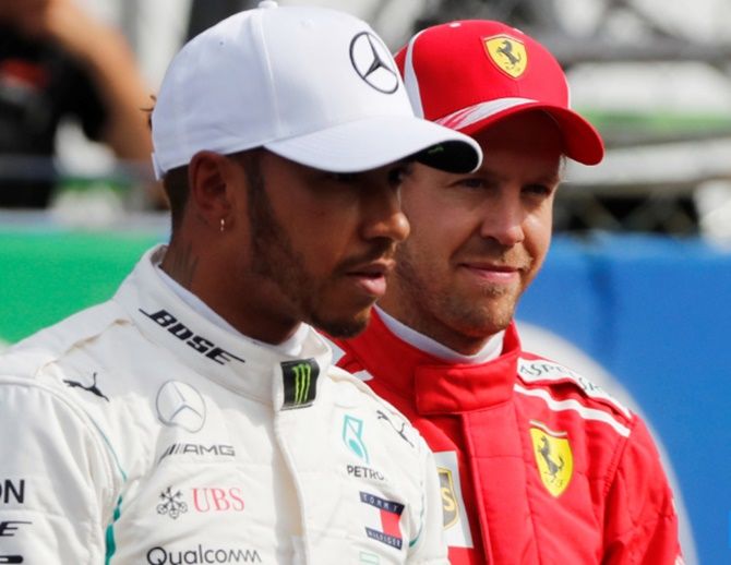  Ferrari's Sebastian Vettel alongside championship leader Mercedes' Lewis Hamilton