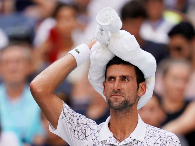 Novak Djokovic keeps cool between games during his match against Portugal's Joao Sousa