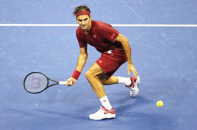 Roger Federer plays a return against John Millman