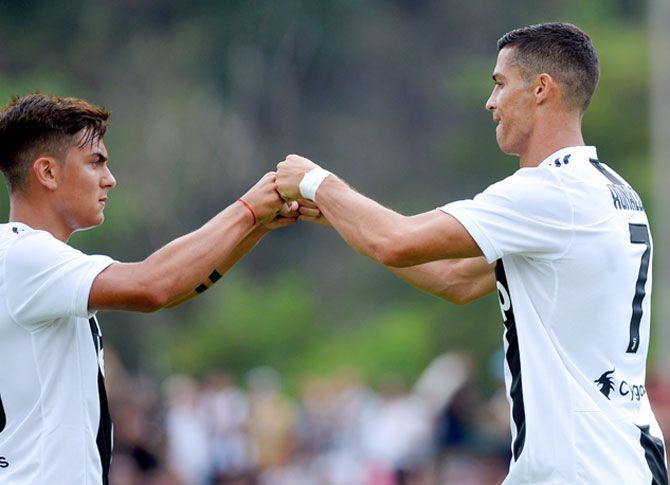 Juventus' Cristiano Ronaldo and Paulo Dybala celebrate a goal 