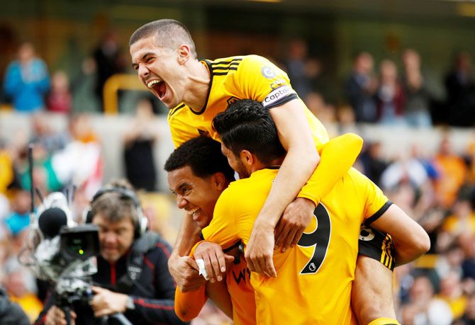 Wolverhampton Wanderers' Raul Jimenez celebrates scoring their first goal with Helder Costa and Conor Coady