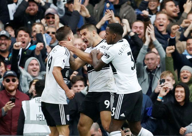 Fulham's Aleksandar Mitrovic celebrates scoring their first goal with Luciano Vietto and Ryan Sessegnon during their match against Watford at Craven Cottage in London on Saturday