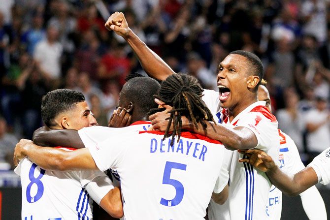 Olympique Lyon players celebrate after Bertrand Traore scores their third goal against Olympique de Marseille at Groupama Stadium in Lyon on Sunday