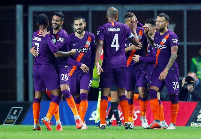 Manchester City's Riyad Mahrez celebrates scoring their second goal with teammates